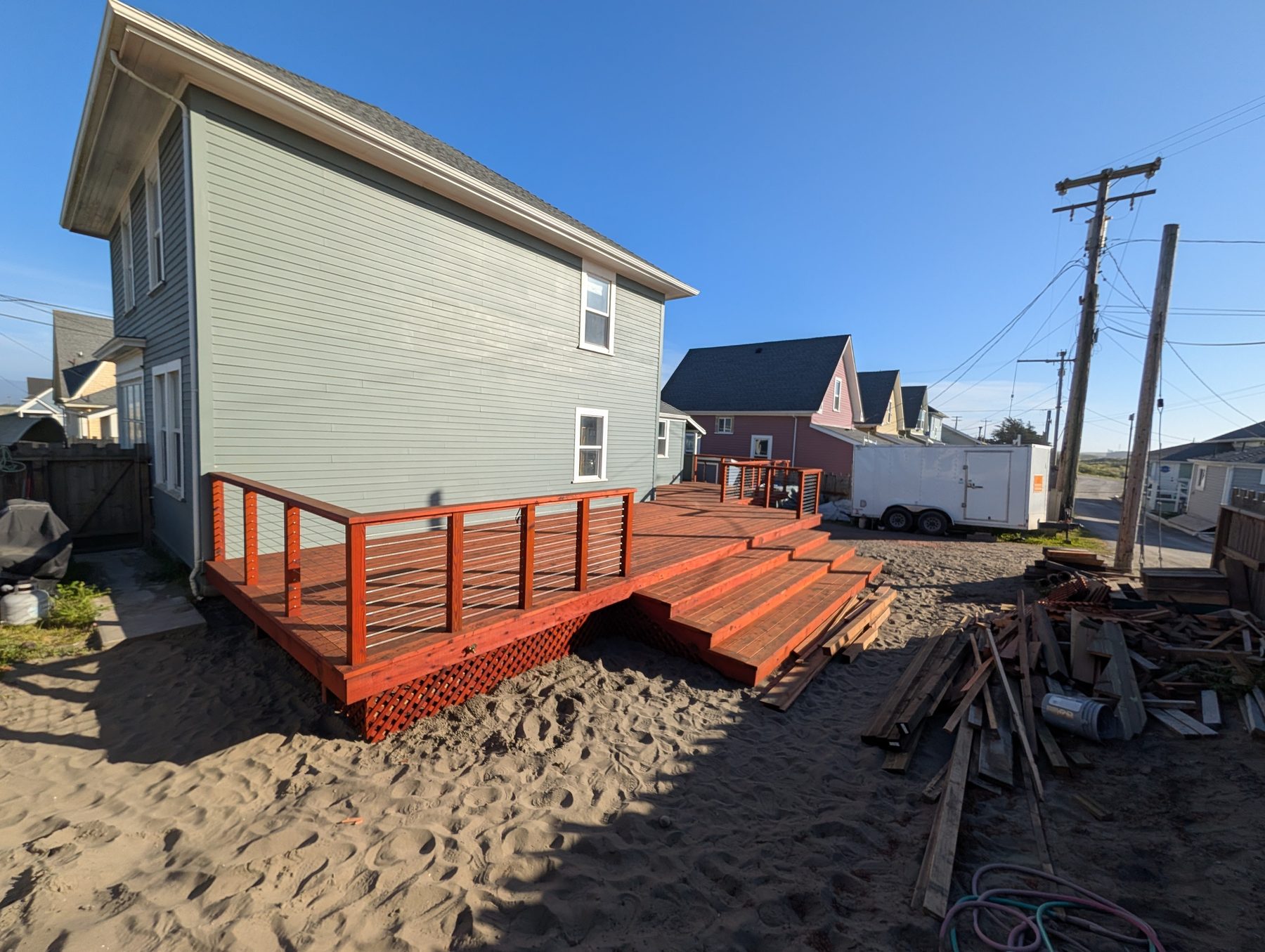 Finished multi-level redwood-toned deck on a coastal Humboldt County home, built by NorCal Exterior