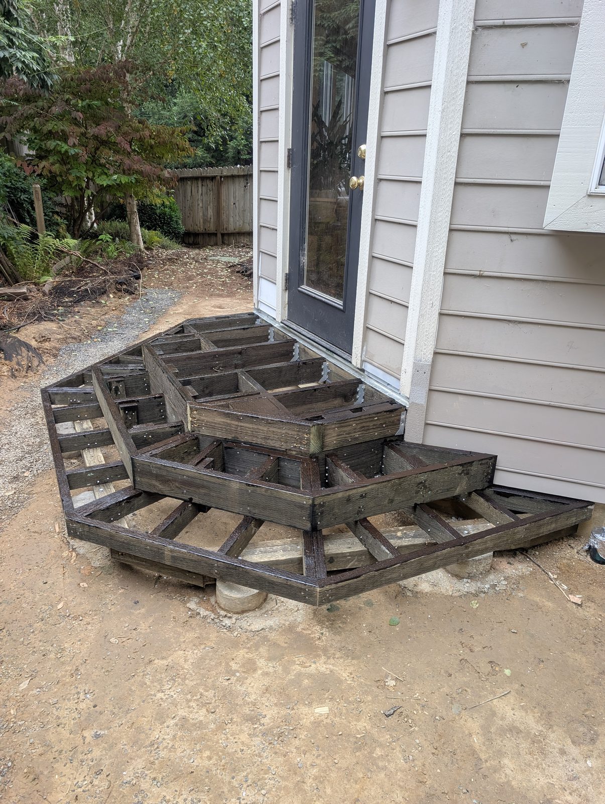 Same deck during construction showing pressure-treated joist substructure and corrosion-resistant hardware