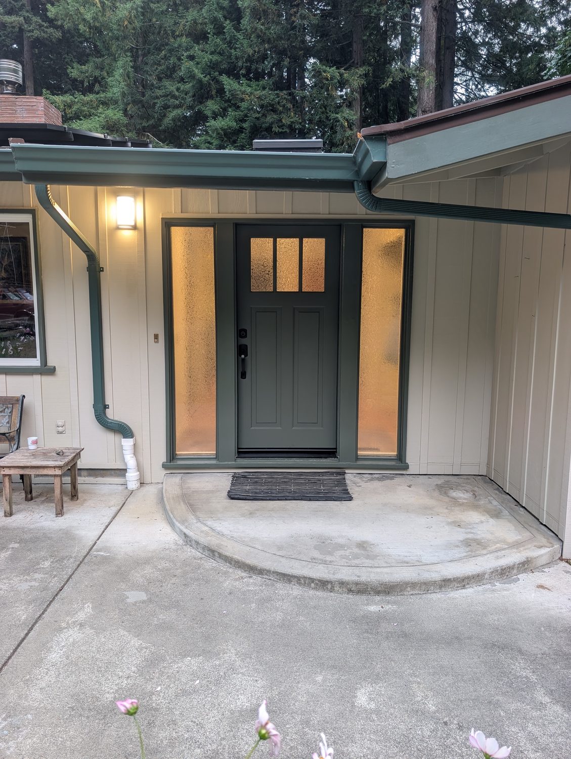 Finished craftsman entryway with green door, frosted glass side lights, and redwood backdrop, recently completed by NorCal Exterior near McKinleyville