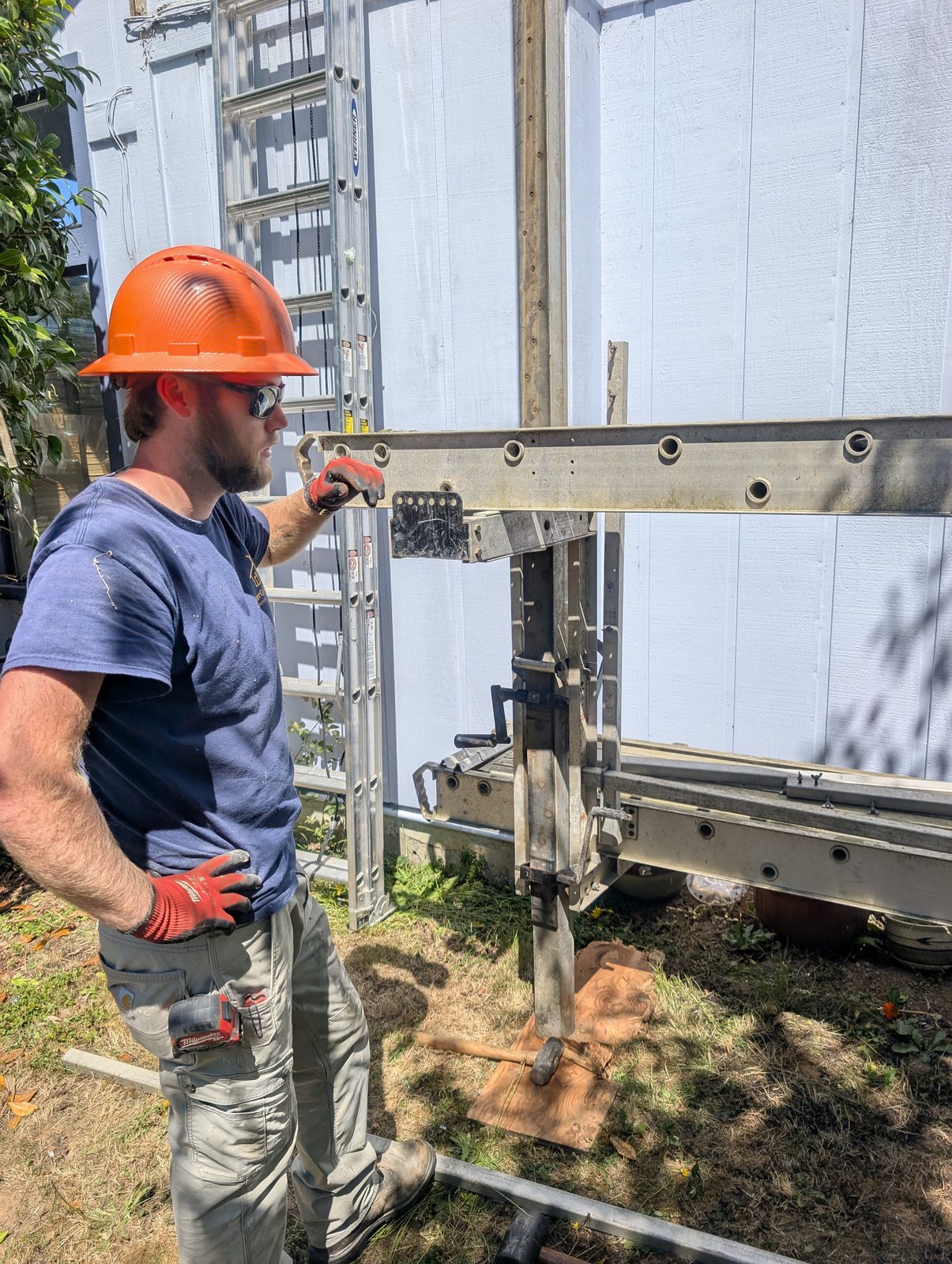 Crew member setting up pump jack scaffolding for the project