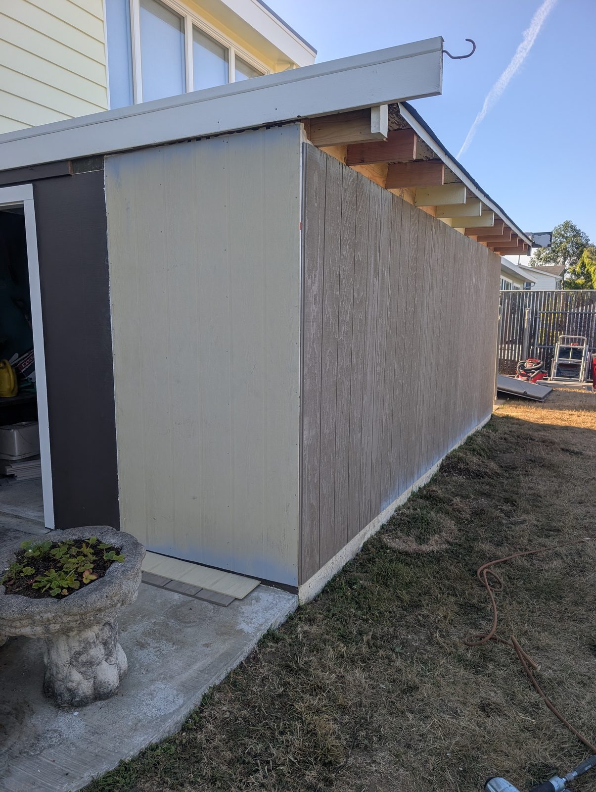 Siding install in progress with new panels going up on a coastal Humboldt County home