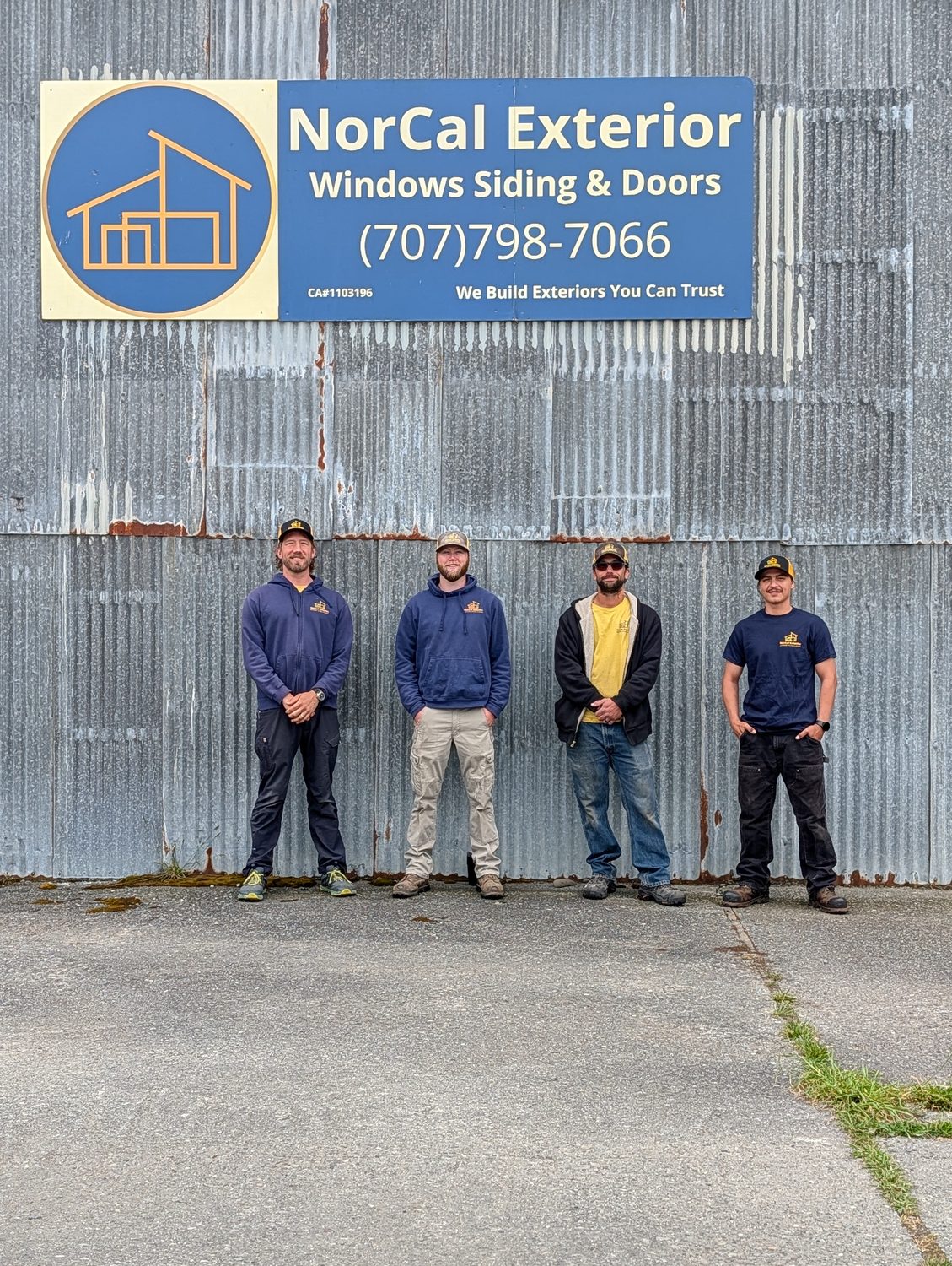 The NorCal Exterior crew lined up in front of the company shop in Arcata beneath the branded sign