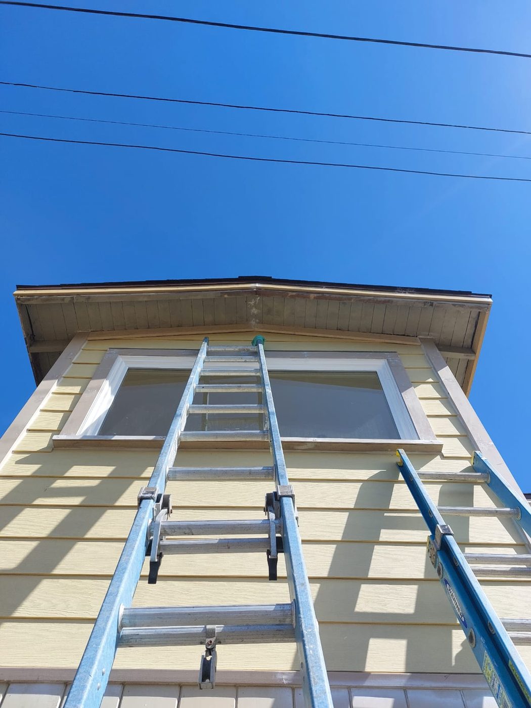 New window being set into an upper-story opening on a Humboldt County home by NorCal Exterior